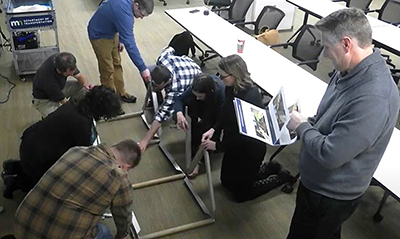 Photo: Employees build a brindge during Lunch and  Learn.
